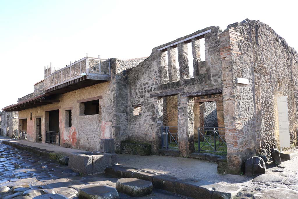 Via dell’Abbondanza, south side. December 2018. 
I.12.5, on left, I.12.1, on right. Looking east along south side.  Photo courtesy of Aude Durand.
