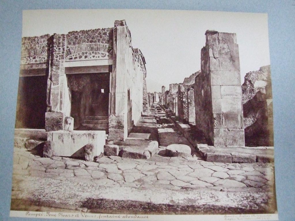 Via dell’Abbondanza. North side. Junction with Vicolo di Eumachia between VII.9 and VII.13. Looking north from junction.
Old undated photograph by Amodio, courtesy of the Society of Antiquaries, Fox Collection.

