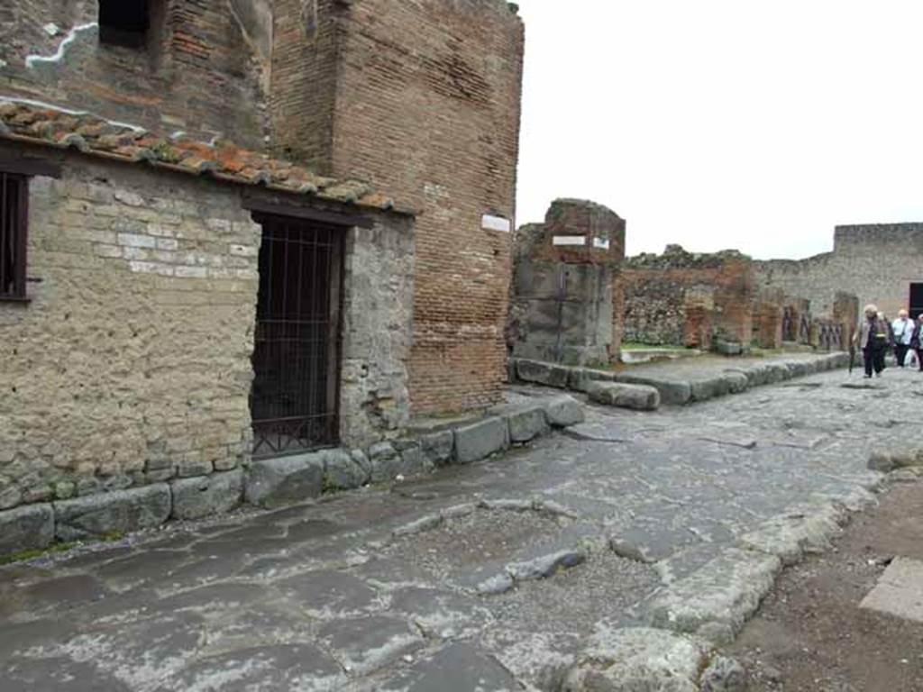 Via delle Terme, south side. May 2010. Looking west to junction with Vicolo delle Terme, between VII.5 and VII.6.