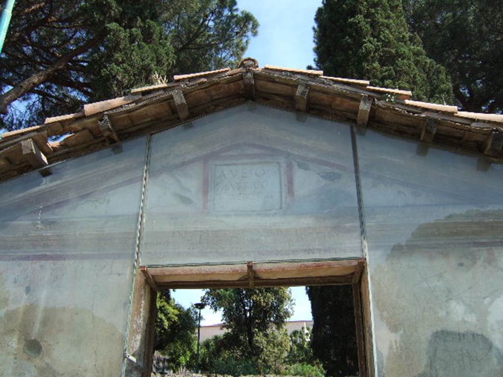 Pompeii Porta Nocera. Tomb 11ES. May 2006. Triangular top with cornice around all three sides and marble plaque above the door.
