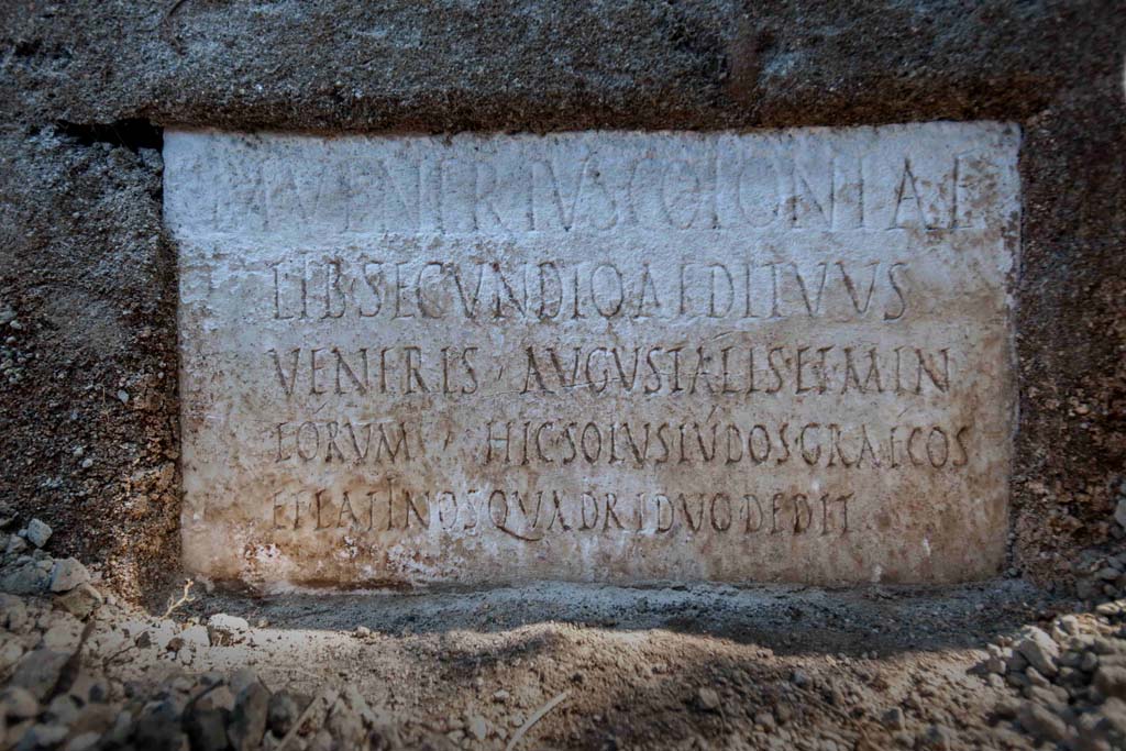 Porta Sarno la tomba di Marcus Venerius Secundio. August 2021. 
On a marble slab located on the pediment of the tomb, a commemorative inscription to the owner Marcus Venerius Secundio makes reference, extraordinarily, to performances at Pompeii that were conducted in Greek, direct evidence of which has never before been found.

The figure of Marcus Venerius Secundio - who also appears in the wax tablet archive of the Pompeian banker Caecilius Giocondo, owner of the domus of the same name on Via Vesuvio - was a public slave and custodian of the Temple of Venus. Upon being freed, he reached a certain social and economic status, as can be understood from the rather monumental tomb, and the inscription: in addition to joining the ranks of the Augustales, or the college of priests dedicated to the Imperial Cult, as the epigraph recalls he "gave Greek and Latin ludi for the duration of four days". "Ludi graeci are to be understood as performances in the Greek language': - observes the Director of the Archaeological Park of Pompeii, Gabriel Zuchtriegel.

Sulla lastra marmorea posta sul frontone della tomba un'iscrizione commemorativa del proprietario Marcus Venerius Secundio richiama, straordinariamente, lo svolgimento a Pompei di spettacoli in lingua greca, mai prima attestati in maniera diretta.

Il personaggio di Marcus Venerius Secundio - che compare anche nell'archivio di tavolette cerate del banchiere pompeiano Cecilio Giocondo, proprietario della domus omonima su via Vesuvio – era uno schiavo pubblico e custode del tempio di Venere. Una volta liberato, aveva poi raggiunto un certo status sociale ed economico, come emergerebbe non solo dalla tomba piuttosto monumentale, ma anche dall'iscrizione: oltre a diventare Augustale, ovvero membro del collegio di sacerdoti dediti al culto imperiale, come ricorda l'epigrafe, "diede ludi greci e latini per la durata di quattro giorni". "Ludi graeci è da intendere come spettacoli in lingua greca - commenta il direttore del Parco archeologico di Pompei, Gabriel Zuchtriegel.

M VENERIVS COLONIAE
LIB SECUNDIO AEDITVVS
VENERIS AVGVSTALIS ET MIN
EORVM HIC SOLVS LVDOS GRAECOS
ET LATINOS QVADRIDVO DEDIT

Photograph © Parco Archeologico di Pompei.

According to Virginia Campbell the reads as:

M(arcus) Venerius coloniae
lib(ertus) Secundio, aedituus
Veneris, Augustalis et min(ister)
eorum. Hic solus ludos Graecos
et Latinos quadriduo dedit.

And translates as:

‘Marcus Venerius Secundio, freedmen of the colony, guardian of the temple of Venus, Augustalis and minister of them. He, on his own, gave Greek and Latin games for four days.

See https://pompeiinetworks.wordpress.com/2021/08/19/the-tomb-of-marcus-venerius-secundio/
