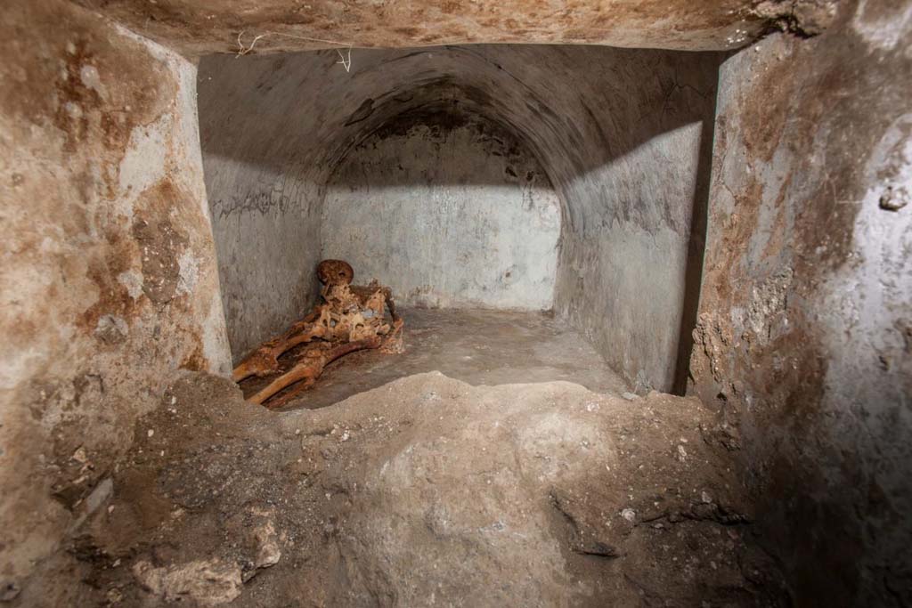 Porta Sarno la tomba di Marcus Venerius Secundio. August 2021. Mummified skeleton in hermetically sealed inner chamber.
No less exceptional than the inscription is the burial of Marcus Venerius Secundio, with one of the best-preserved skeletons ever found in the ancient city. 
The deceased was buried in a small cell of 1.6 x 2.4 metres, located behind the main façade

Scheletro mummificato in un ambiente ermeticamente chiuso.
Non meno eccezionale dell'iscrizione risulta la sepoltura di Marco Venerio Secundio. 
Si tratta di uno degli scheletri meglio conservati ritrovati nella città antica. 
Il defunto fu inumato in una piccola cella di 1,6 x 2,4 metri posta alle spalle della facciata principale.

Photograph © Parco Archeologico di Pompei.
