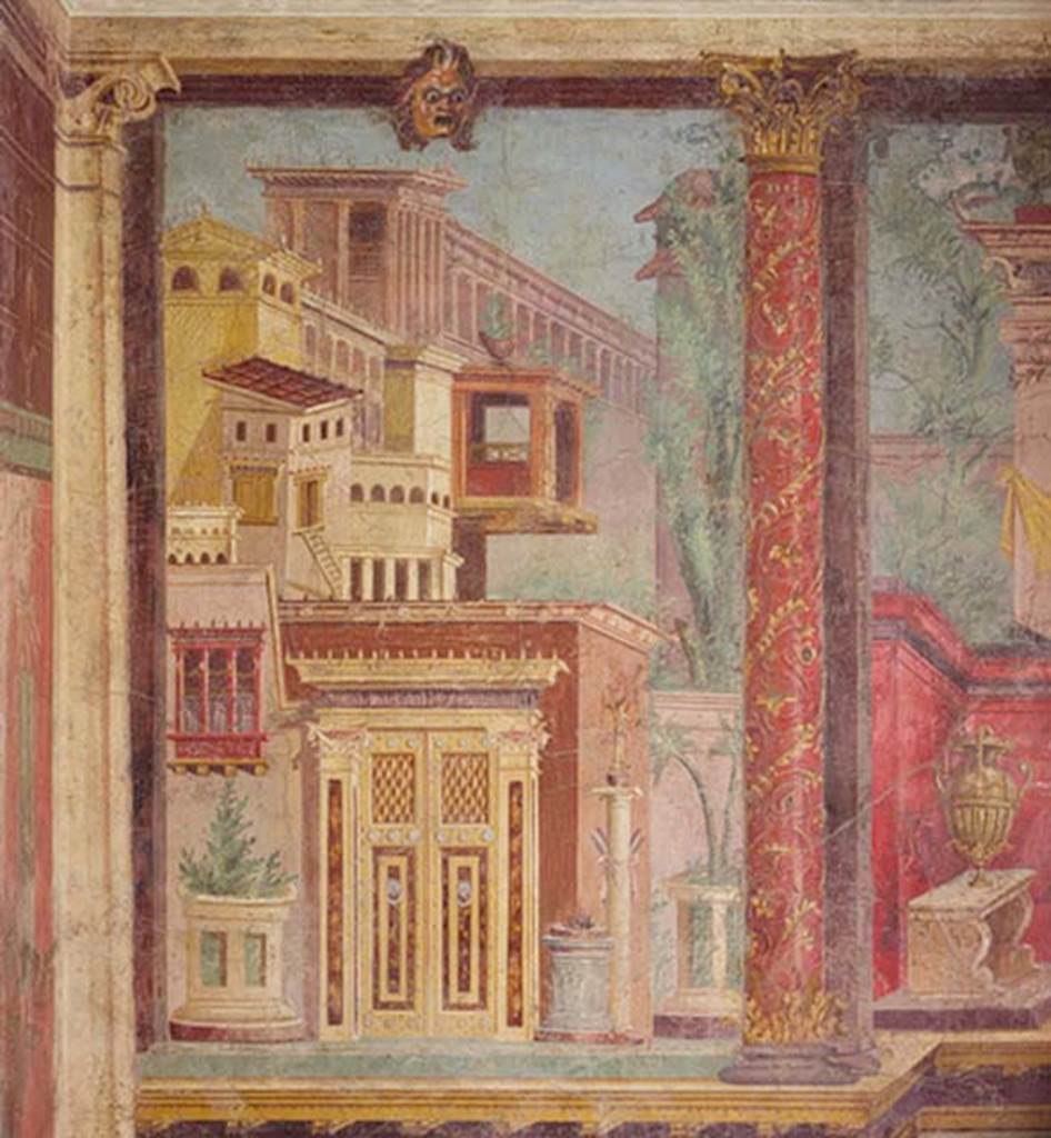 Villa of P Fannius Synistor at Boscoreale. Cubiculum M. South end of the west wall. Panel painted with buildings, an ornate door, an altar and a statue on a column. At the top of the panel is a mask and on the right a red column ornately painted with flowers and climbers.
The painting has a considerable amount of detail not visible in the photo. There are people in the window and above the door frame, there are phalluses along the canopy. See Bergmann B., 2010, in Roman Frescoes from Boscoreale. New York: Metropolitan Museum of Art. p. 30-1, figs. 68-72.