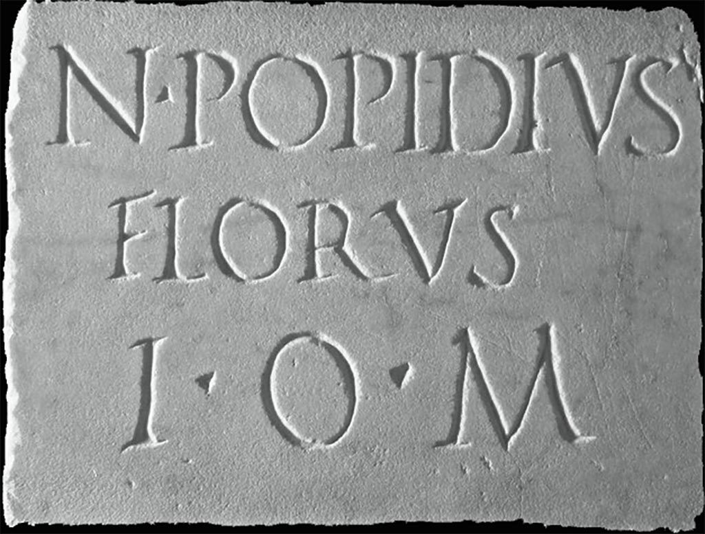 Boscoreale. Villa of Numerius Popidius Florus. Plaque found opposite the south portico. 
Now in Boscoreale Antiquarium, inventory number 34149.
N POPIDIVS
FLORVS
I O M

N(umerius) Popidius
Florus
I(ovi) O(ptimo) M(aximo).

Numerius Popidius Florus. Jupiter is the greatest.

